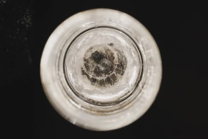 A circular object with a few layers and a transparent bubble in the center
