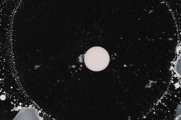 Abstract liquid with a white dot in the center