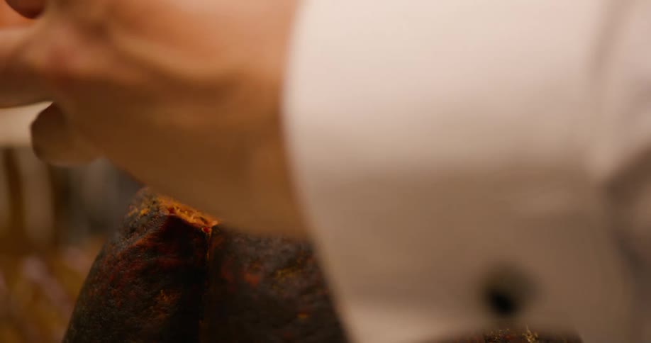 Hand removing a piece of a pumpkin