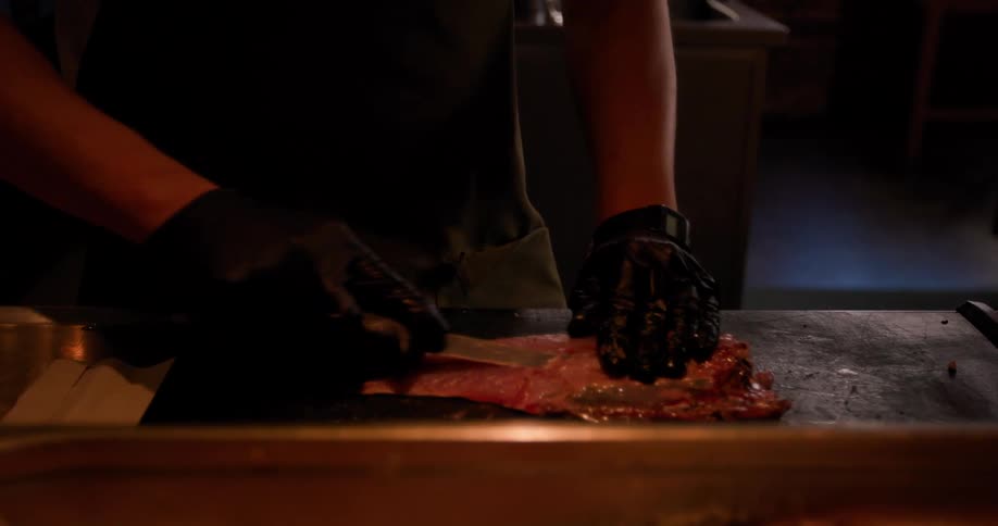 Man cutting meat on a cutting board