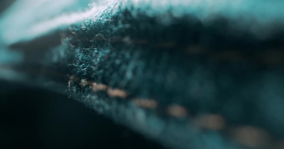 A light is shining on the stitches of the fabric