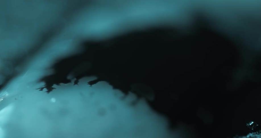 Abstract black liquid expanding on a white surface