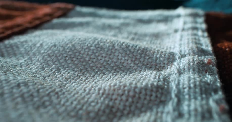A long sheet of fabric is laying down