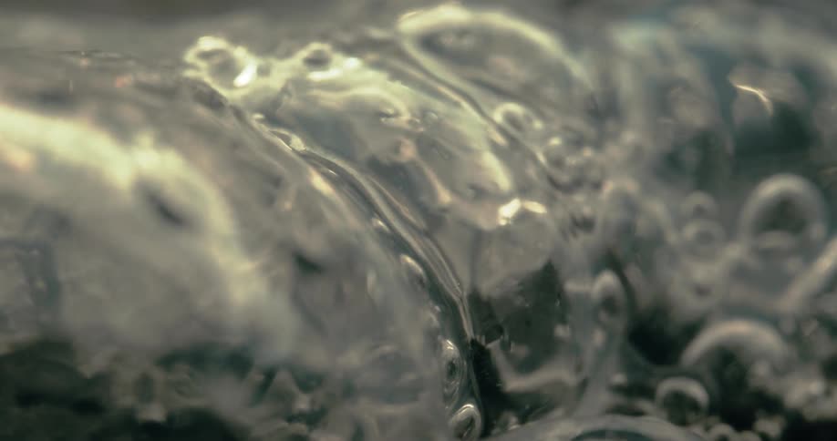 Close up of liquid bubbles bursting
