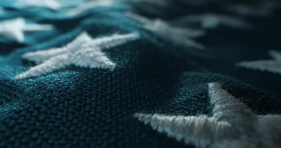 A blue blanket with several white star designs sewn on it