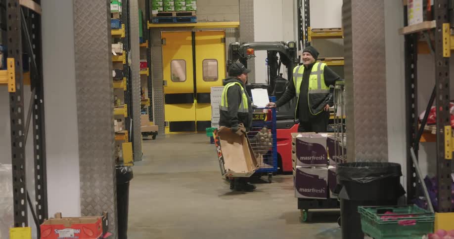 Employees stop to talk in the warehouse