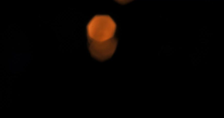 Blurry orange lights moving around at night