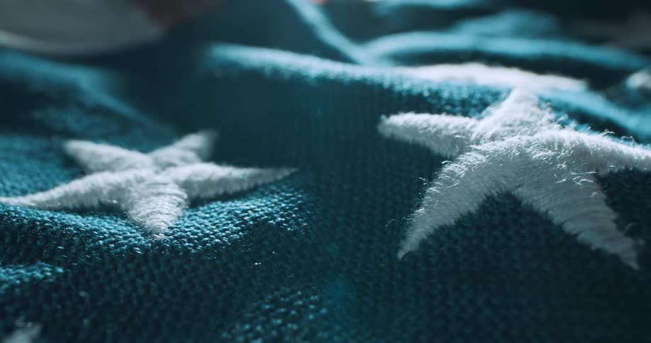 A woven with white stars object lays