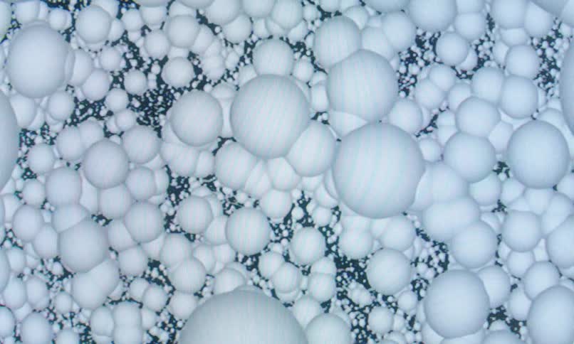 Extreme closeup of dense white spheres or bubbles forming an abstract organic texture