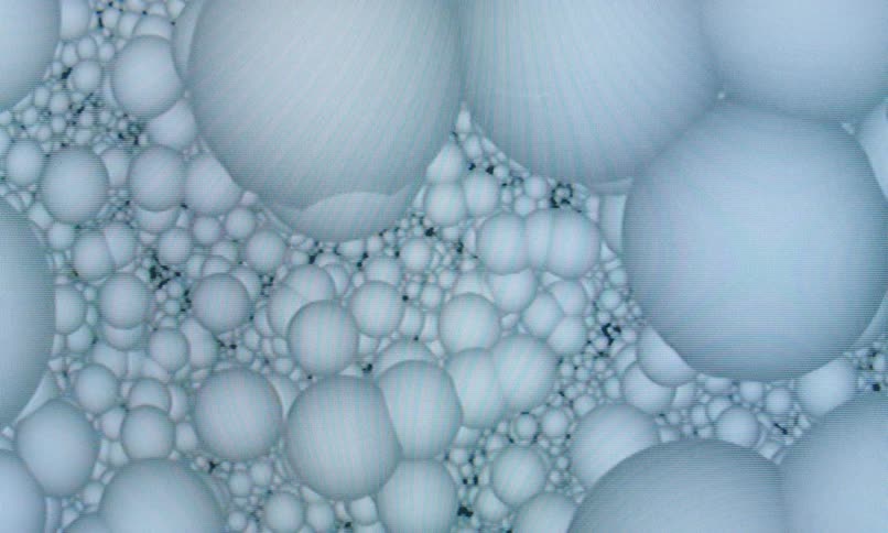 A microscopic or computergenerated view of densely packed translucent spheres forming an abstract organic structure