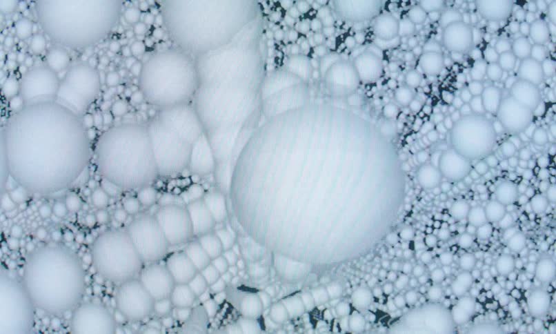 White spheres floating in space form columns and other patterns