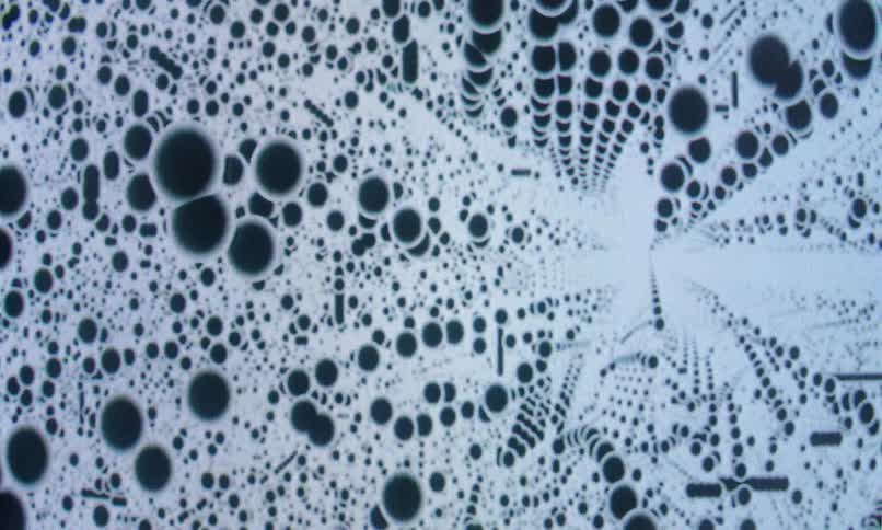 Black colored dots with white surroundings dimensional and abstract