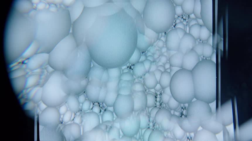 Close up of clustered translucent spheres resembling bubbles in an abstract scientific style