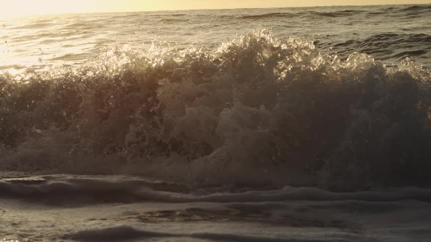 Closeup of sea waves at sunset