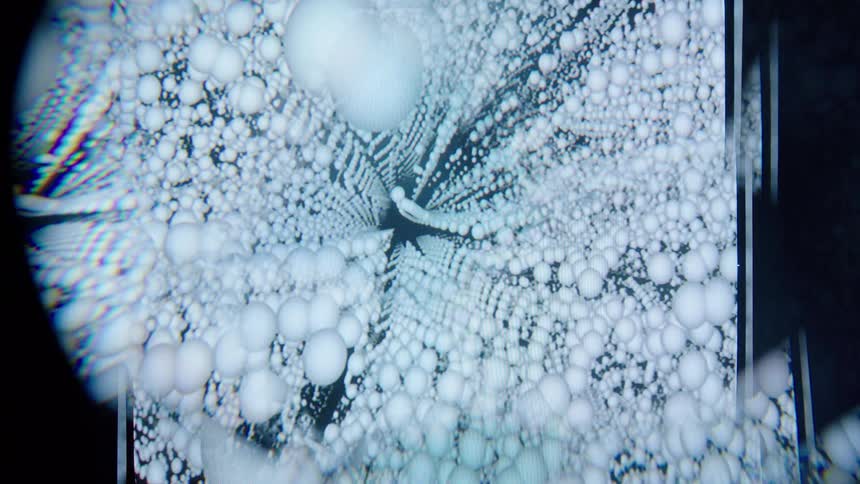 White spheres form columns against a black background