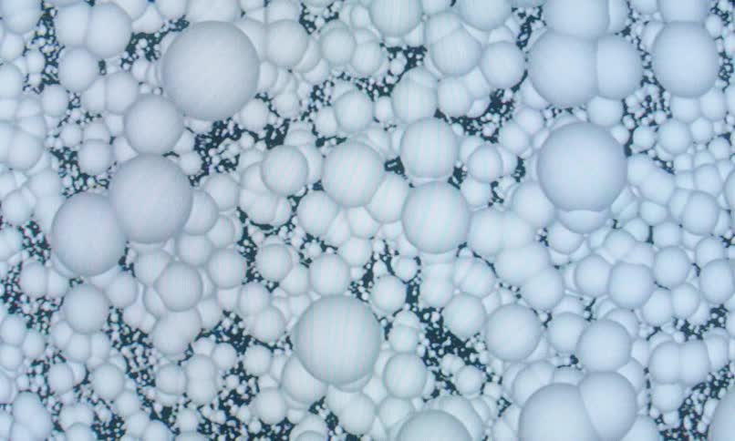 Patterned white spheres against an abstract dark background