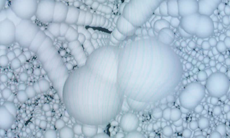 A surreal computergenerated composition of tightly clustered white spheres forming a dense abstract texture