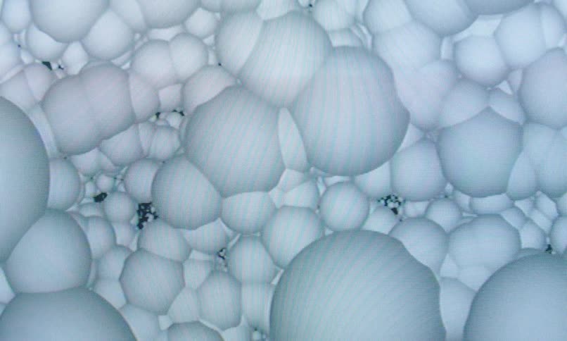 White orbs fill the area and are connecting together in the screensaver