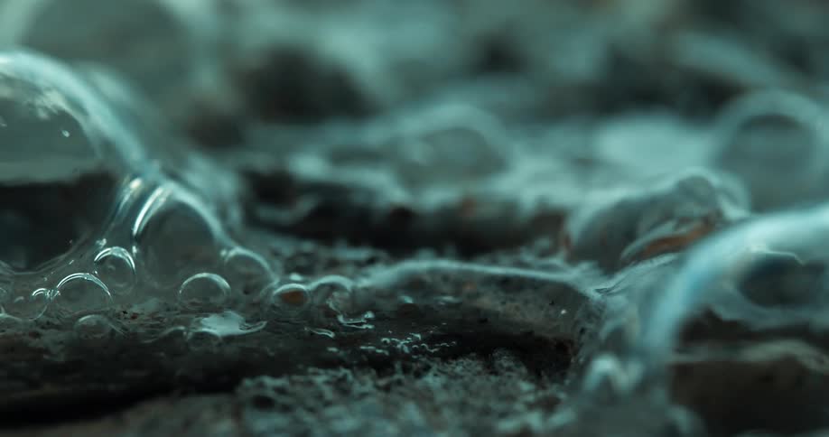 The liquid is melting and foaming on the wood