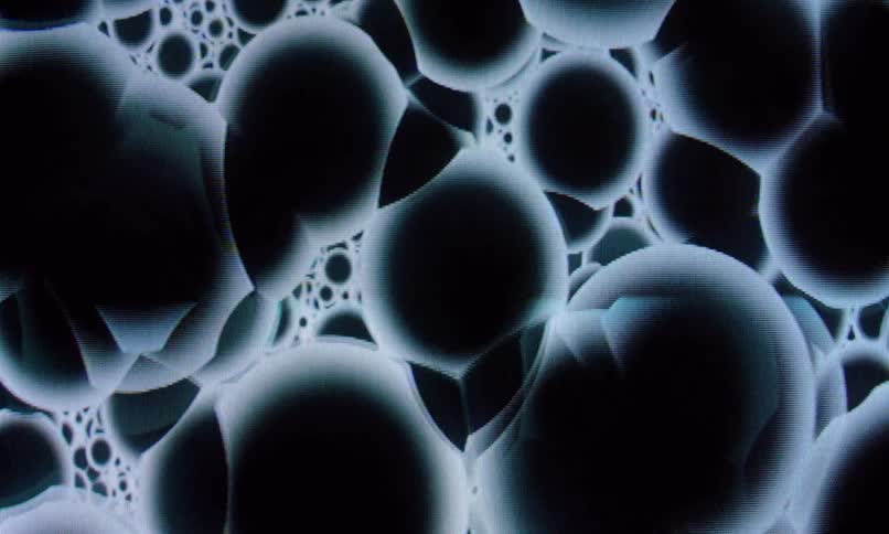 The screensaver shows black orbs passing through each other