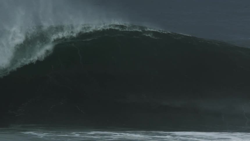 Man coming out of a huge wave