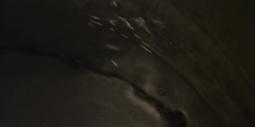 The water slowly moves and bubbles below