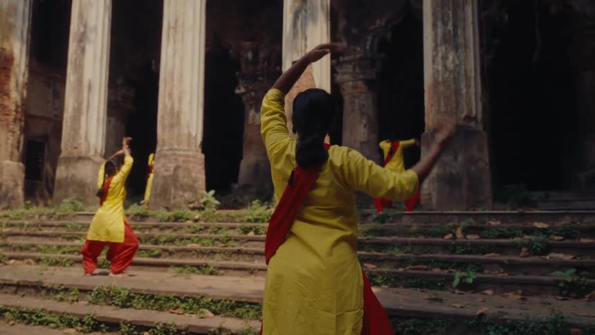 Women are practicing tai chi by the ruins