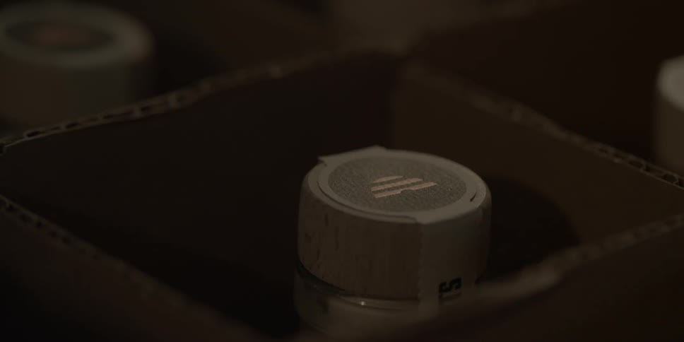 Someone places gin in a box