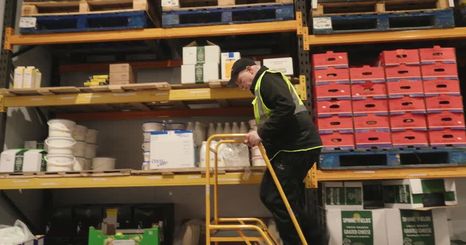 An employee stocks the shelves of a warehouse