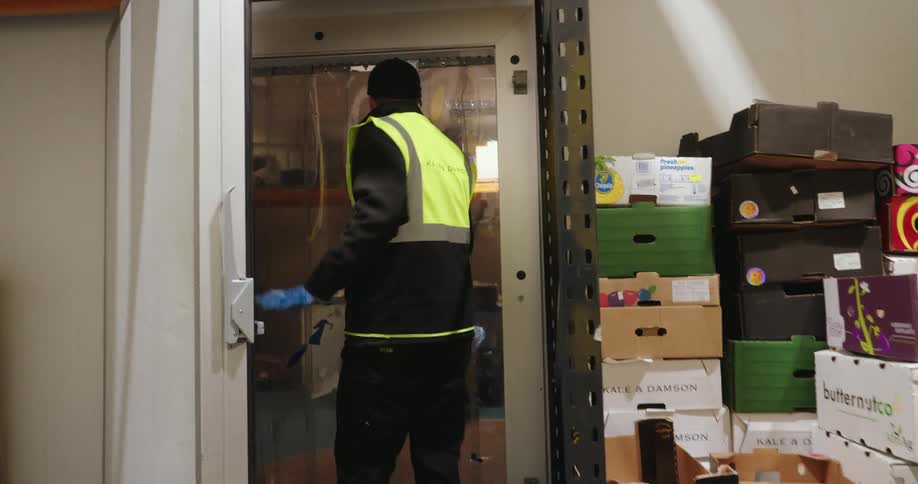Coworkers work in a warehouse facility that contains food supplies
