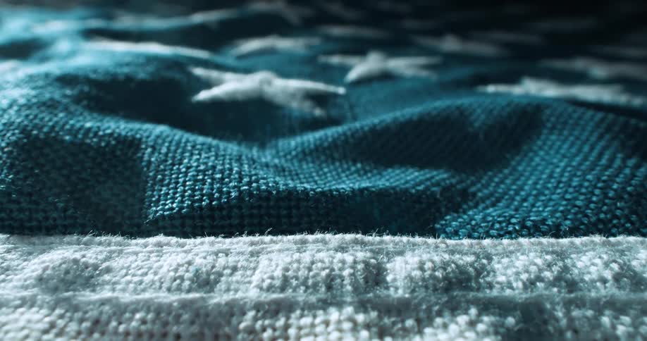 A handstitched american flag lays flat