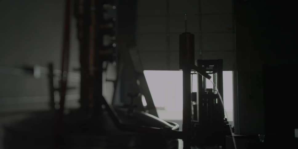 A water spout is shooting water in this dark shop