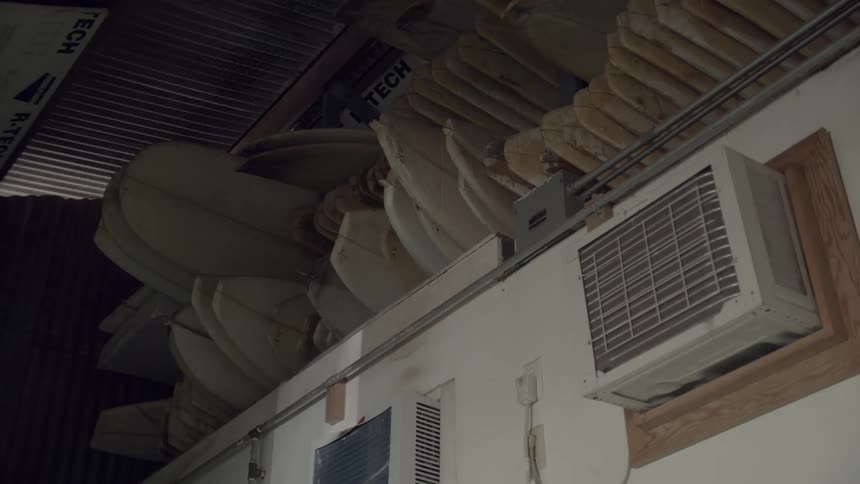 Air conditioners line this wall in spots