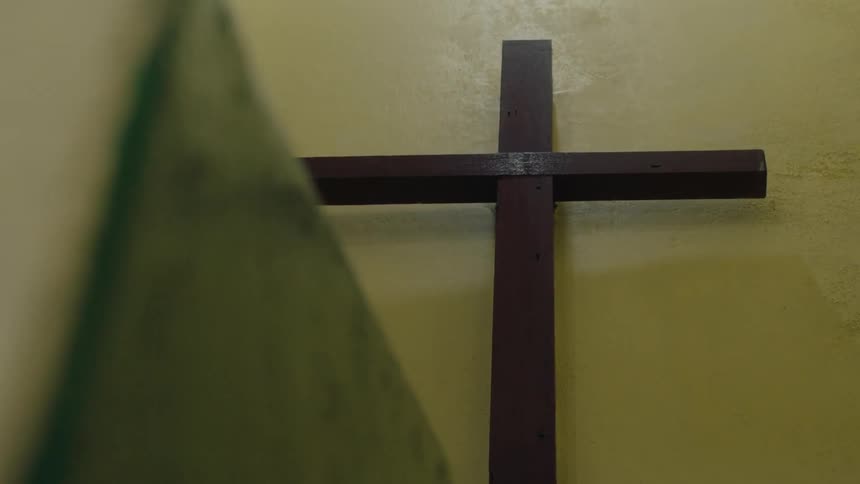 Close up of a wooden cross hung on a wall