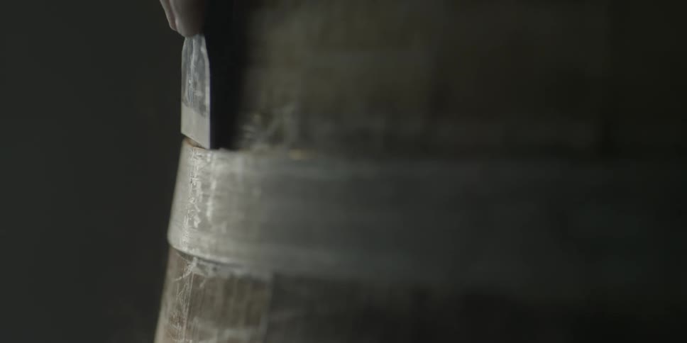 A tool is used to secure a metal ring on a barrel