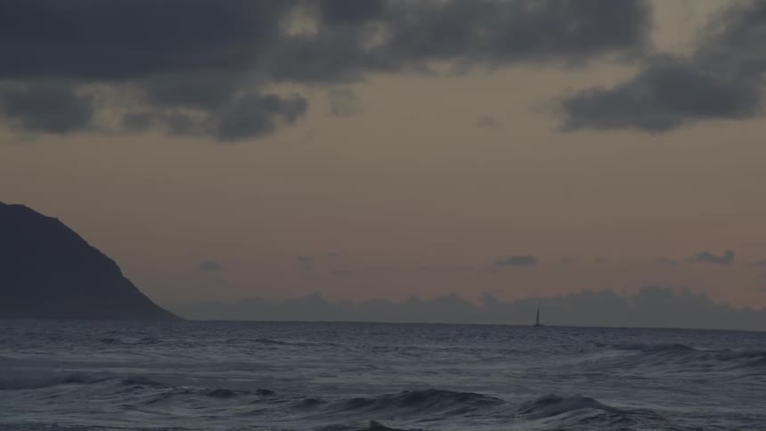 The shoreline has rough waves at dawn