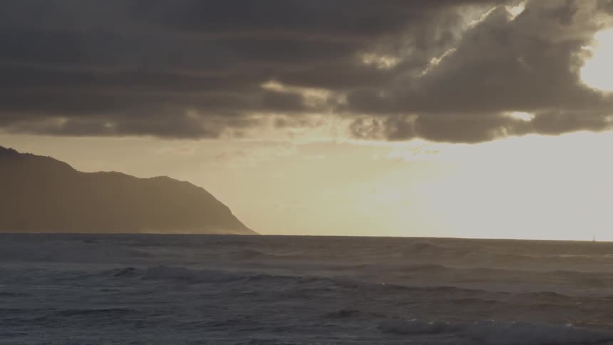 Ocean waves wash ashore at sunset