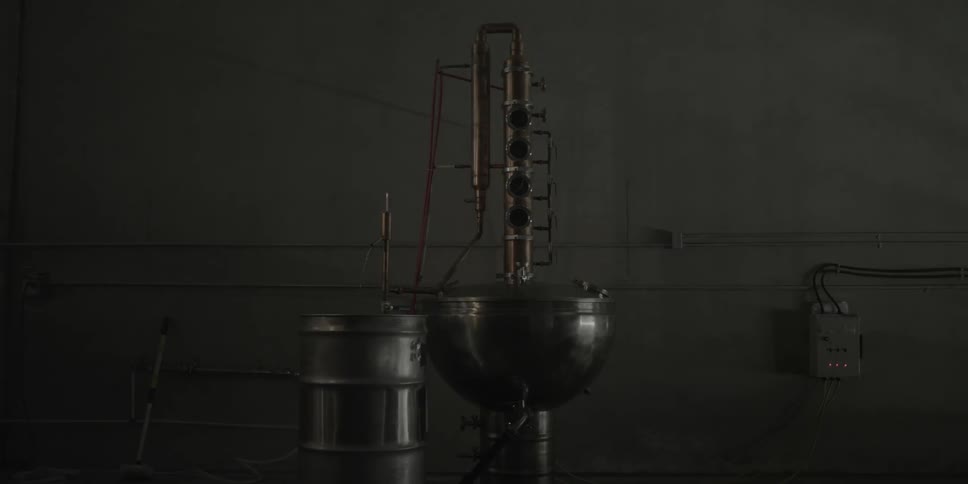 Metal equipment sits in a dark factory