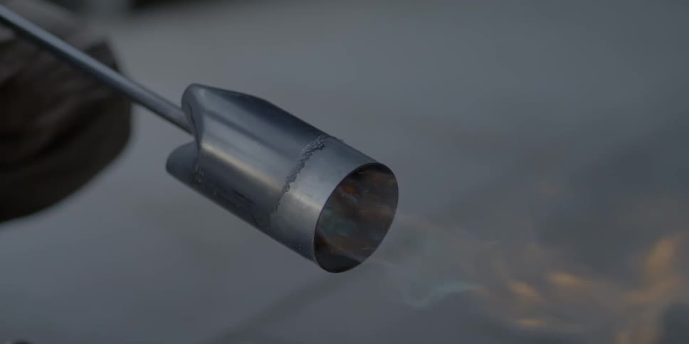 A person lights the flame of a torch