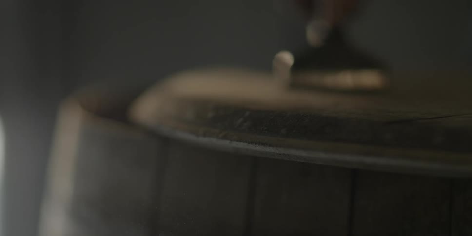 Close up of a brush sanding a piece of wood