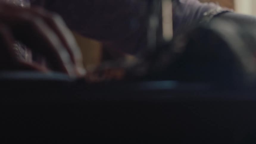 Woman using a sewing machine to sew fabric