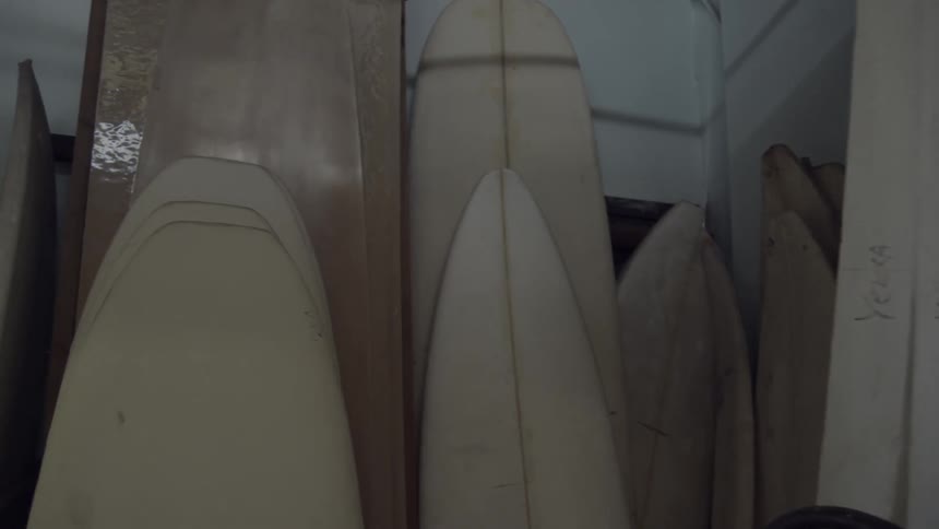 A shop is full of wood and surfboards