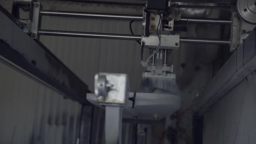 Factory equipment brushes a board