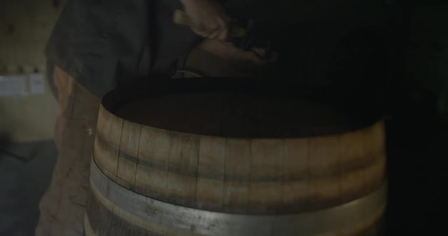A man knocks the ring off of a barrel
