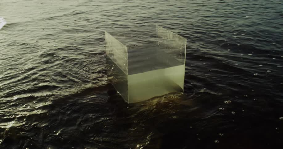 Transparent box with static water in shallow waters of a beach