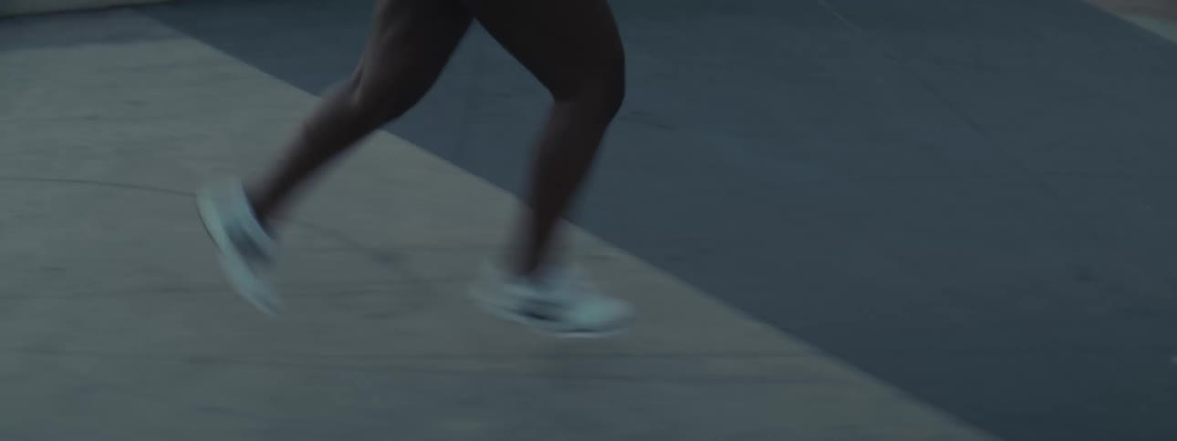 Woman with headphones taking a morning run outdoors