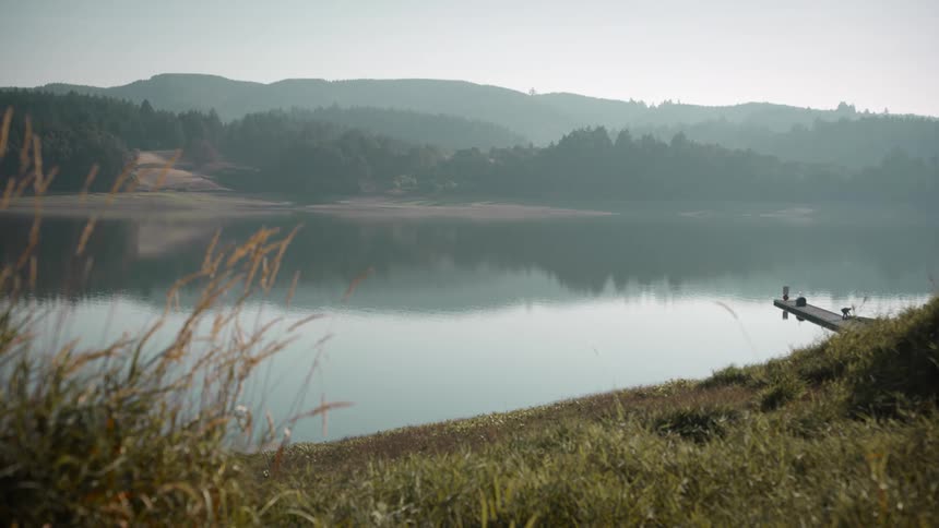 Landscape of a calm lake with mountains on the horizon
