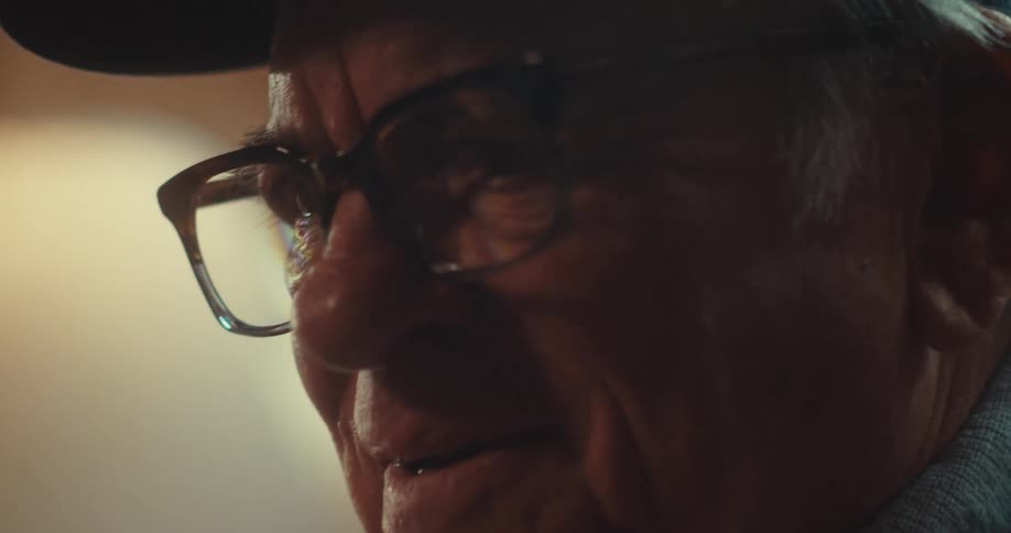 Elderly man laughing and showing emotion while indoors