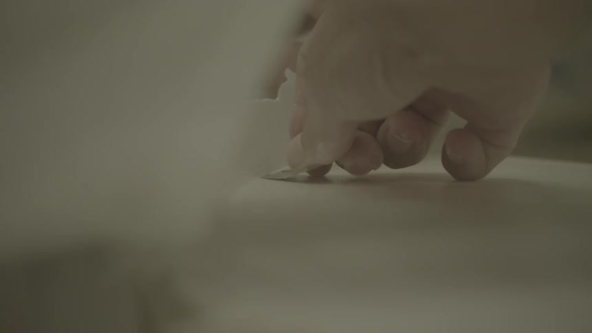 A person is applying a decal to a board