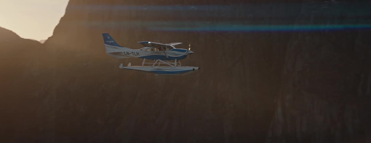 Single engine plane flying near snowy mountains
